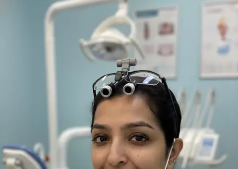 Dentist with headlamp and loupes at AB’S Dental Guntur